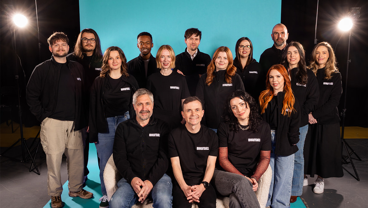 Digital16 team photo with an electric teal background